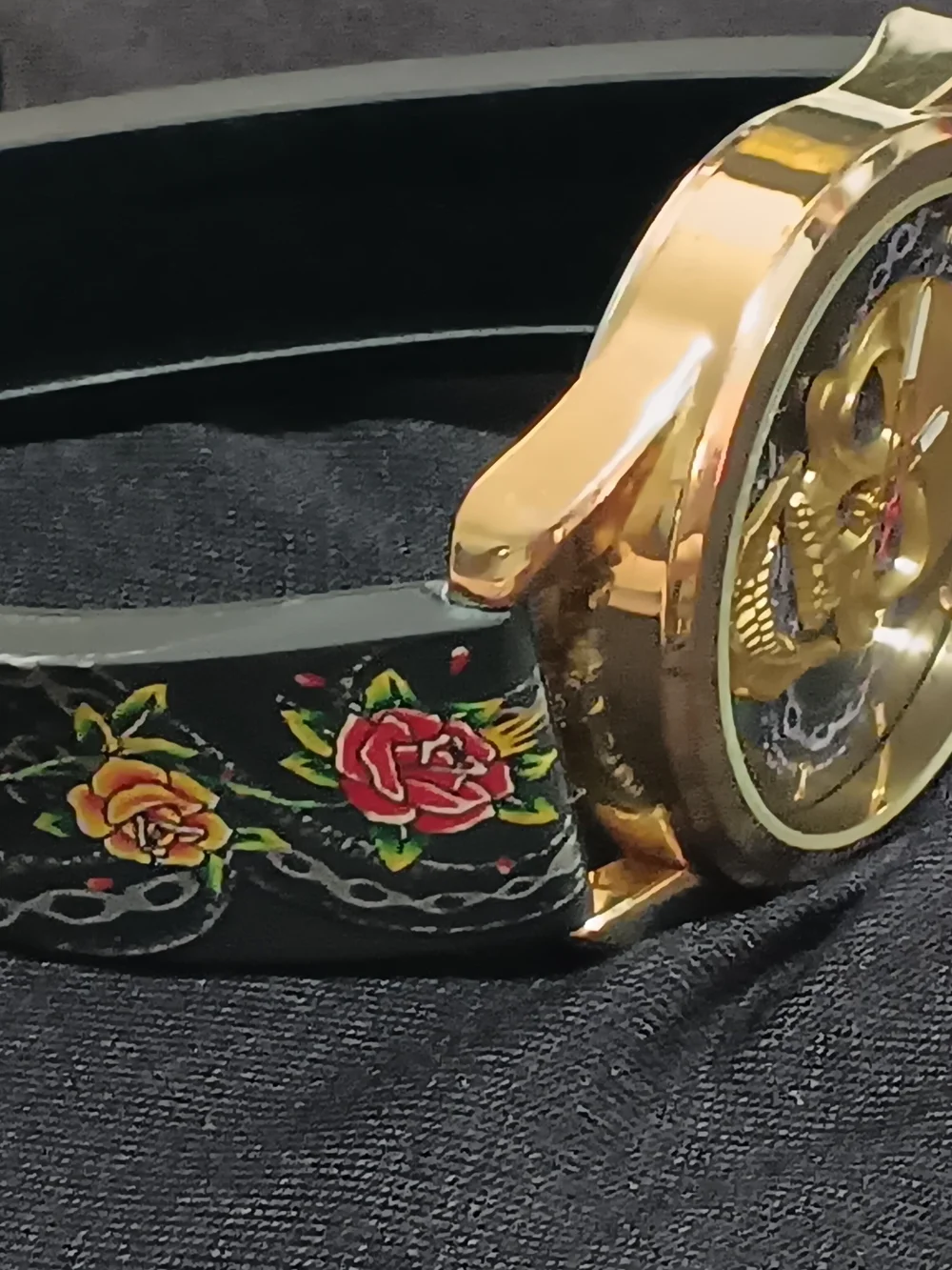 Ed Hardy Gold-Tone Skull Dial Watch with Black Strap and Red Accents